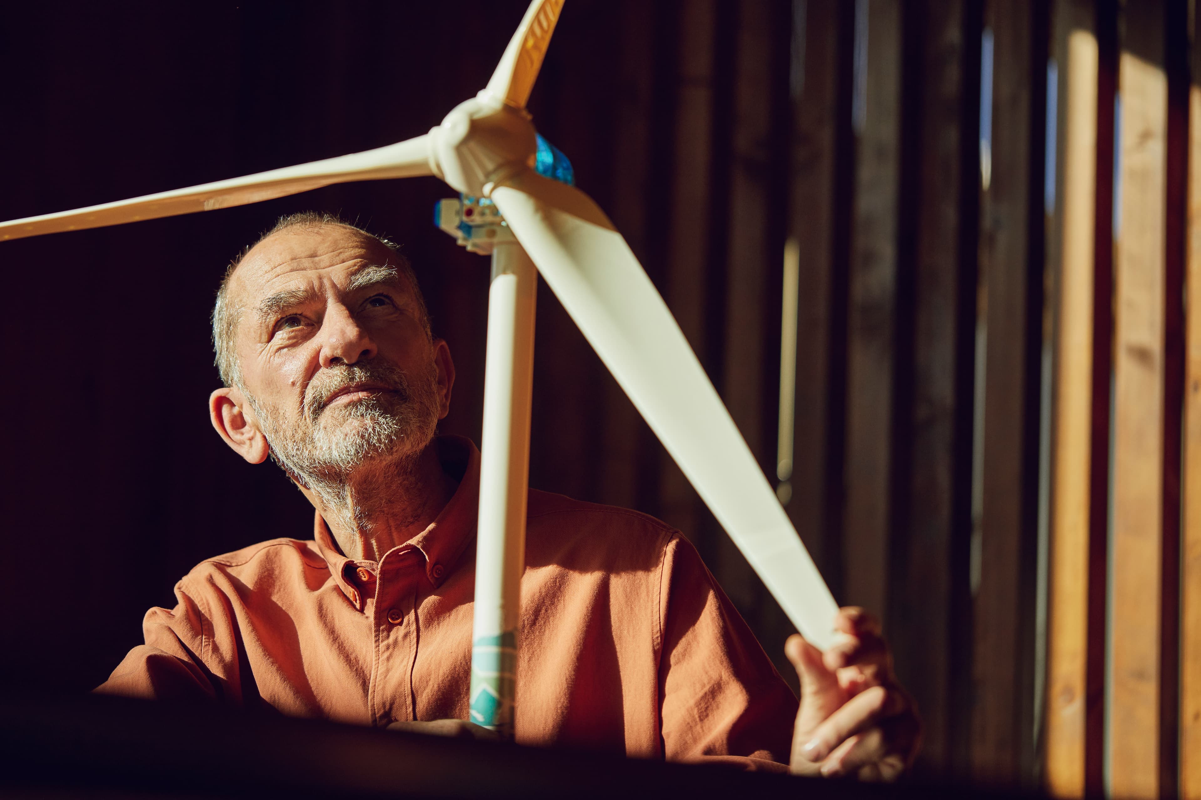 Elderly man with a wind turbine